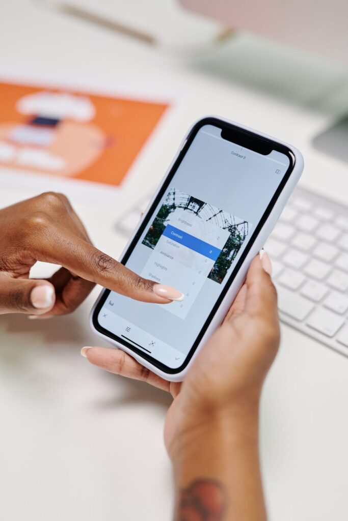 Person using a smartphone to manage a social media account